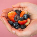 Hand Holding Mixed Berries & Gummies